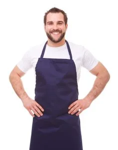 Young man with blue apron on white background